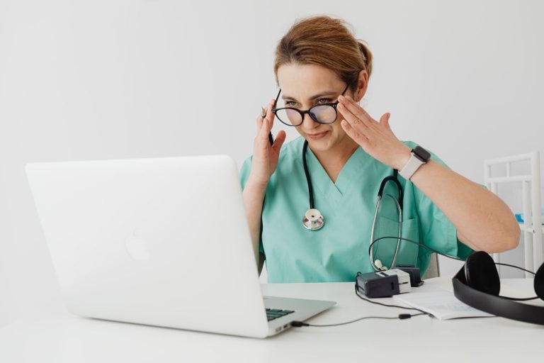 First GP appraisal after CCT: a newly qualified GP reviewing an appraisal portfolio on a laptop