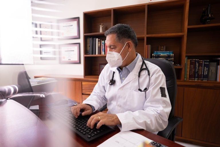 GP appraisal evidence: a doctor updating an appraisal portfolio on a computer