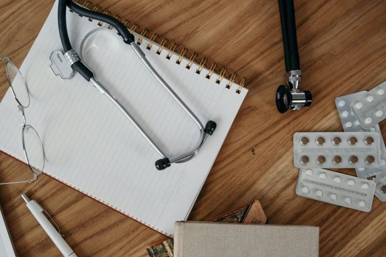 Significant event reflection: a blank notebook, stethoscope and pen ready for writing up learning